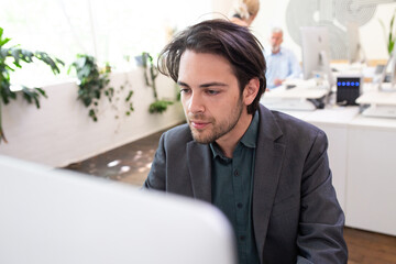 Close-up of 20-something male looking at computer screen