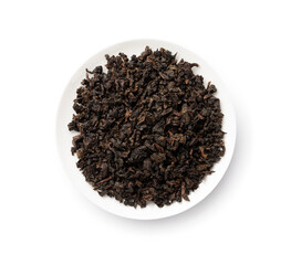 Tea leaves. A pile of dried oolong tea leaves in a white porcelain plate.
