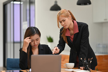 Asian business woman stressed from being blame at work, scolding from a coworker or from her boss,...