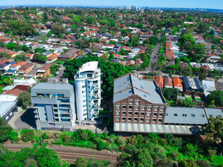 Obraz premium Panoramic Aerial Drone view of Suburban Sydney housing, roof tops, the streets and the parks