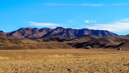 Fototapeta na wymiar Ger in Mongolia countryside with mountains in the background 