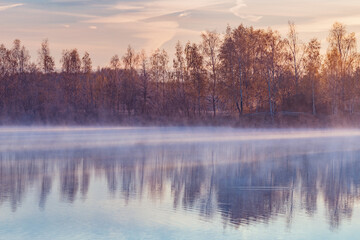 Fog above the lake at cold morning.