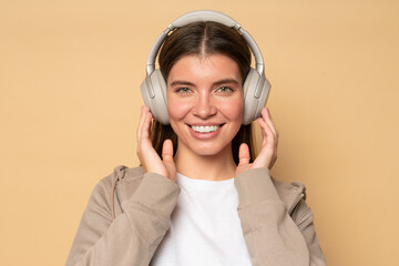 Portrait of woman listening to favorite radio station with daily podcast in big wireless headphones