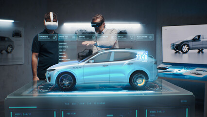 Two development engineers in the studio are designing an eco-friendly sustainable standard electric...