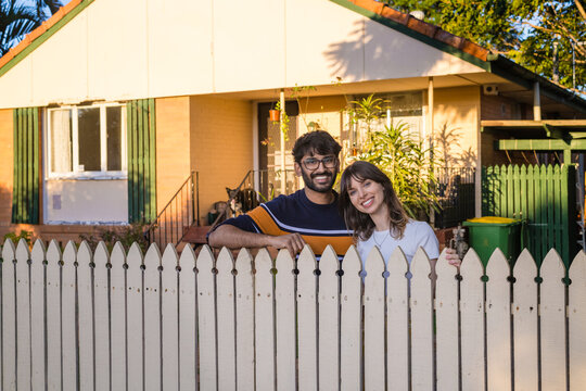 happy couple in front of their home