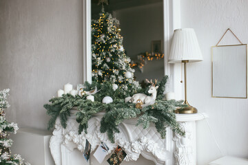 Christmas interior in retro style. White fireplace and mirror with christmas tree garland.