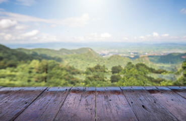 Naklejka na ściany i meble wooden table and beauty blur sky and mountains as background.
