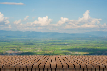 wooden table and beauty blur sky and mountains as background.