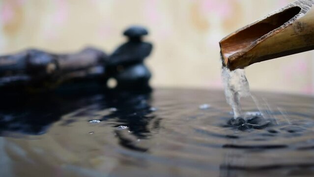 Spa water flows from bamboo gutter pipes.
