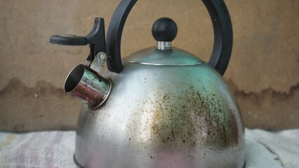 Black spots on a burnt teapot