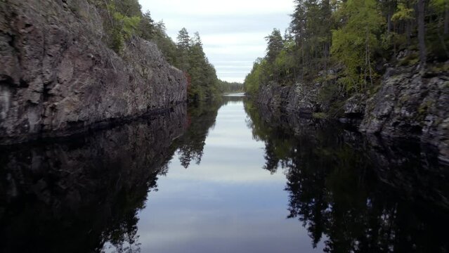 Fly close over water of oblong lake in forest, autumn day in Sweden prt 2