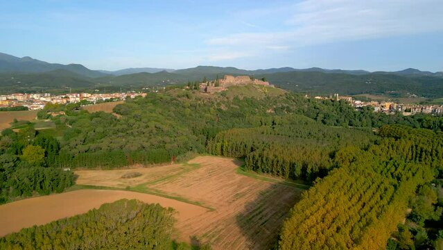 Hostalric aerial images medieval town in Catalonia touristic castle on top of the mountain Flight approaching castle tree farming forestry