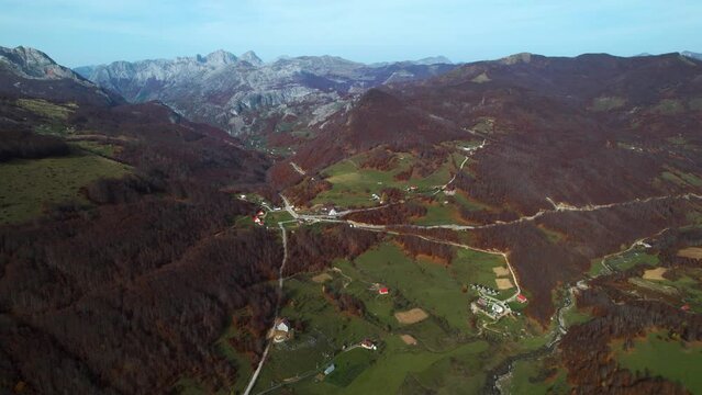 Tourist village of Lepushe in Albania into valley with meadows surrounded by forests and mountains in autumn