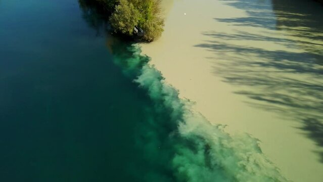Two merging river of blue and brown collor in the town of Geneva Switzerland in 4k