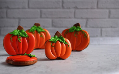 gingerbread in a glaze in the form of a pumpkin on Halloween on a gray background