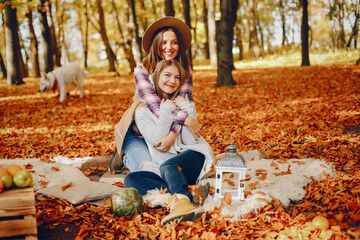 Beautiful girls have fun in a autumn park