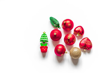 Top view of christmas decorations and a fir tree model on a white background. Flat lay. Copy space