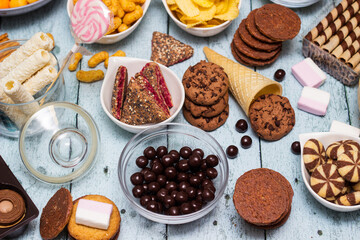 Salty and sweet snacks. Table of salty and sweet snacks. Large group of unhealthy food