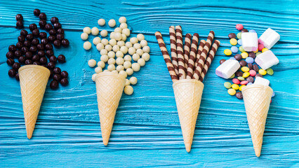 Ice cream cones with colorful candies, cookies, and chocolate balls