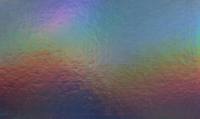 high res full frame macro photo of abstract pastel iridescent holographic foil background with...