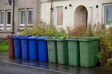 Obraz premium Wheelie bins in row for refuge collection outside council residential building