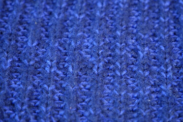 Fototapeta na wymiar Details of knitted woolen fabric. blue textile background. Woolen Texture Background, Knitted Wool Fabric, Hairy Fluffy Textile