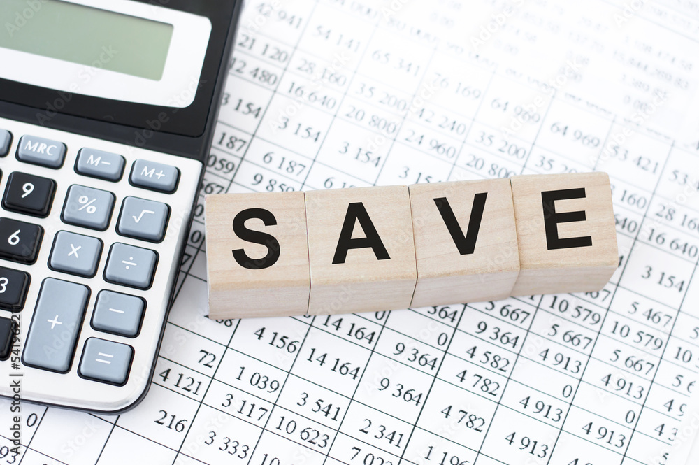 Poster word save. save text on wooden blocks and calculator. business concept image.