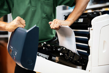 Technician hand open cover photocopier or photocopy to fix repair copier paper jam and replace ink...