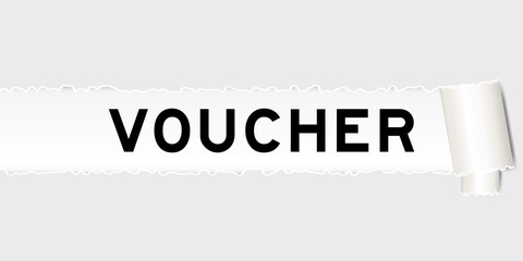 Ripped gray paper background that have word voucher under torn part