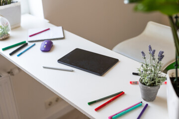 modern digital tablet with pen on a wooden desk