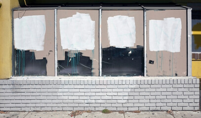 Shuttered store front with blocked out windows.
