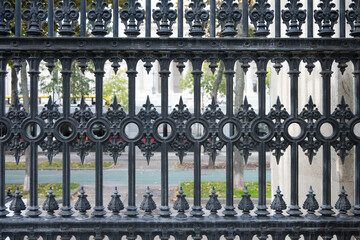 Closeup black wrought iron fence public place