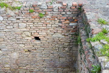 Excavation ancient Roman brick wall corner overgrown