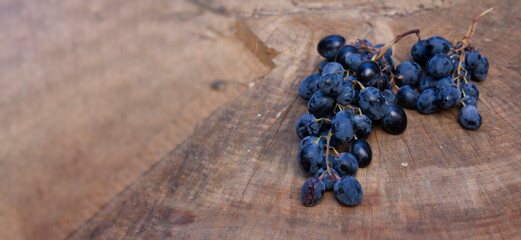 Horizontal banner with delicious and fresh red grapes on a stump. Juicy bunch of grapes on a wooden...