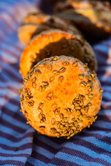 Pumpkin flavor orange color glaze over sesame seeds on sweet macaron sandwich cookies - 541989686