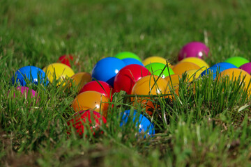 heap of colorful plastic balls are lying in the garden