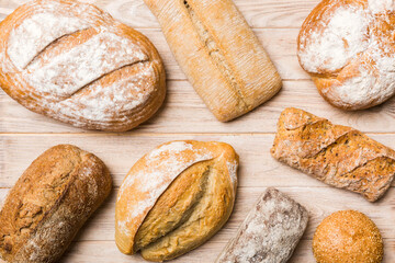 Homemade natural breads. Different kinds of fresh bread as background, top view with copy space