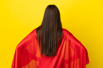 Super Hero Brazilian woman isolated on yellow background in back position