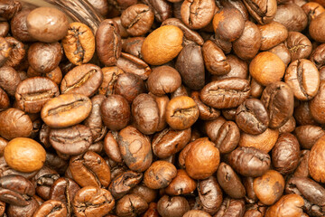 Roasted coffee beans scattered on the table.