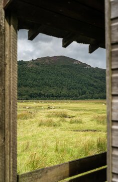 Vertical shot of a landscape under the clouds of Penmaenpool, Wales