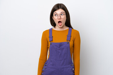 Young Russian woman isolated on blue background doing surprise gesture while looking to the side