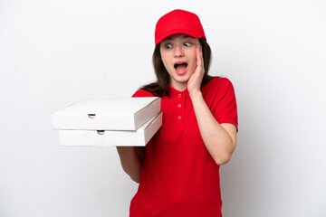 Young Russian pizza delivery picking up pizza boxes isolated on white background with surprise and...
