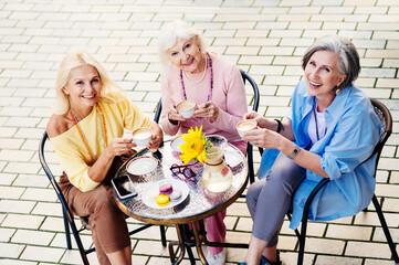 Beautiful senior women bonding at the bar - Beautiful happy senior women shopping in the city...