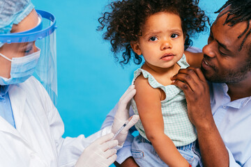 Peple gettig vaccine for covid-19 virus, vaccination against coronavirus - Father and litthe baby...