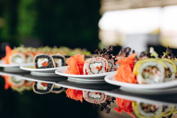 The table is served with four types of sushi with fish, eel, avocado and shrimp. Restaurant concept.