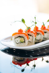 Japanese sushi cuisine. Rolls with salmon, shrimp, crab and avocado. Top view of a variety of sushi. Rainbow sushi roll.
