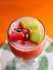 fresh fruit slices with jelly and sweet syrup in the glass