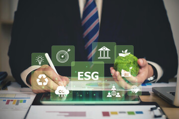 ESG environment social governance investment business concept. Businessmen use a computer to...