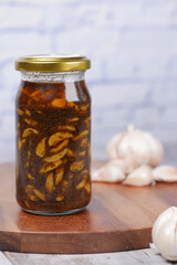 Homemade Garlic Pickle in a glass jar on table ,