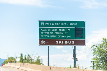 Park City, Utah highway at ski resort town by road sign with parking lots for Wasatch mountains...